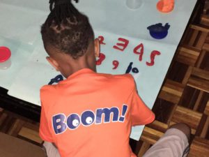 Child in a boom t-shirt painting