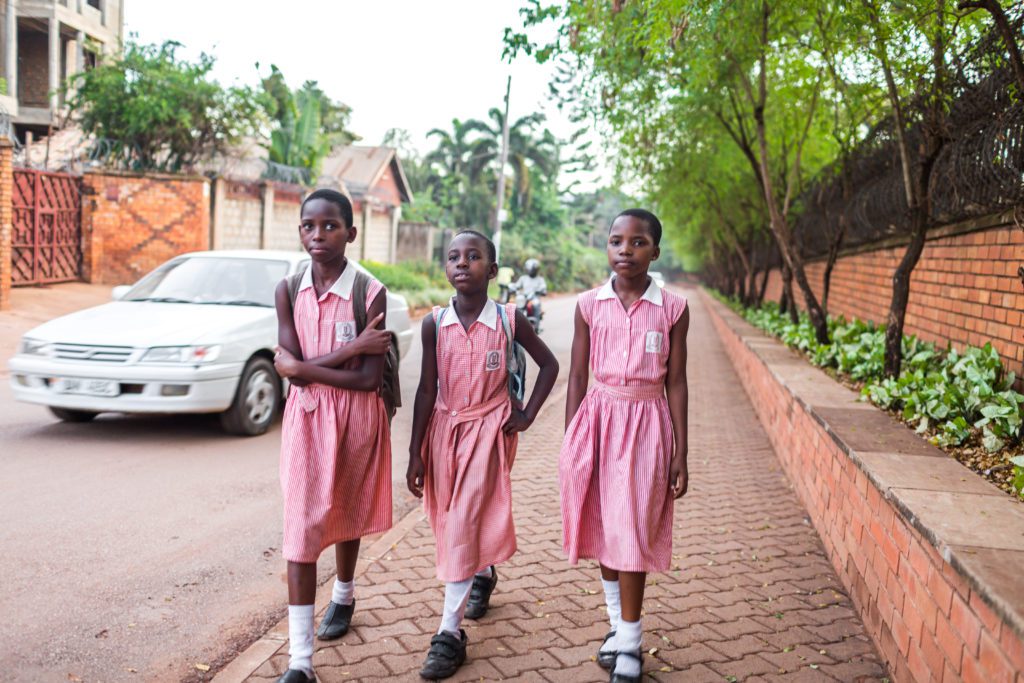 Three African girls walking in uniform Three African girls walking in school uniforms