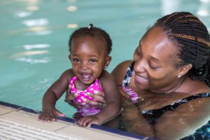 African mother and daughter in a swimming pool